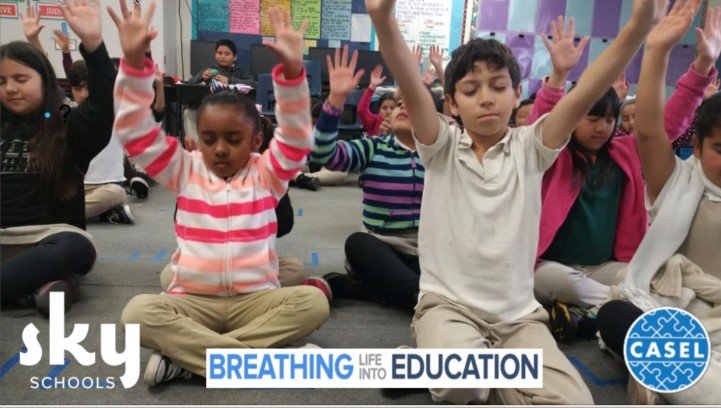 Students practicing SKY Breath Meditation in a bright classroom guided promoting focus and emotional wellness.