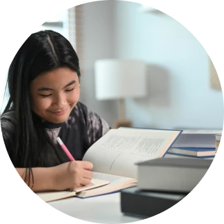 Student writing in a notebook, creating a focused environment for learning and self-confidence.