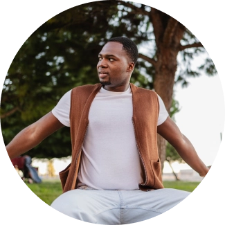 Happy participant in white t-shirt and brown vest stretching his arms out