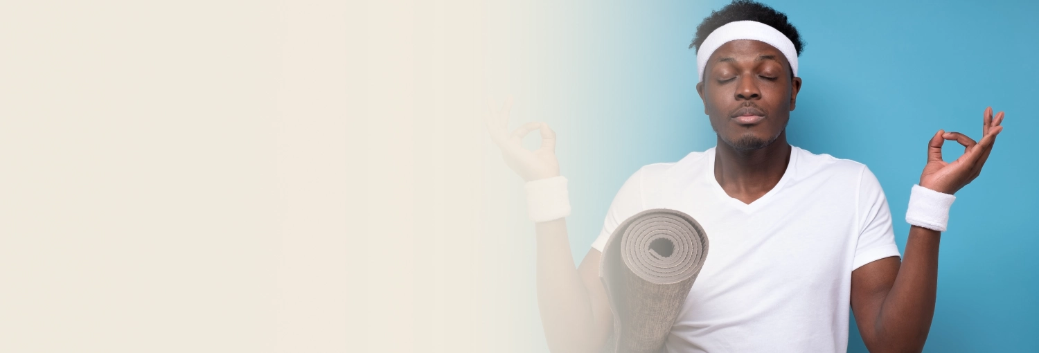 A young man sitting with eyes closed after the yoga session