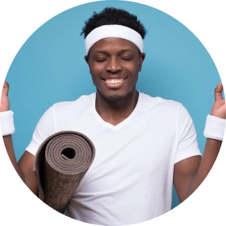 A young man sitting with eyes closed after the yoga session