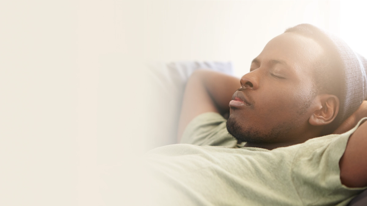 A man wearing a grey beanie fell asleep in the sofa