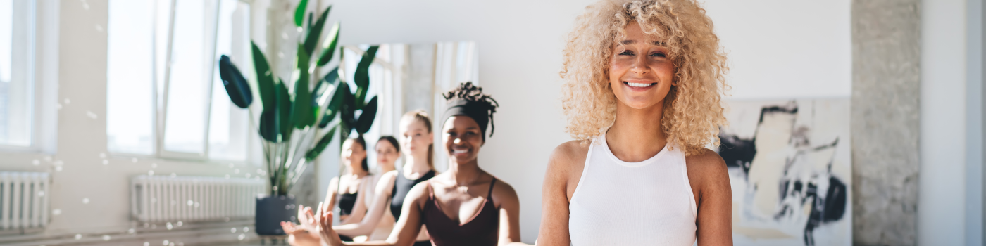 Group of women from different ethnicity sitting in a bright room after a meditation session