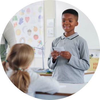A boy giving his speech in the classroom with confidence